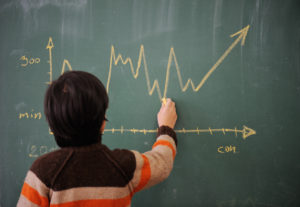 Kid writing diagram on blackboard